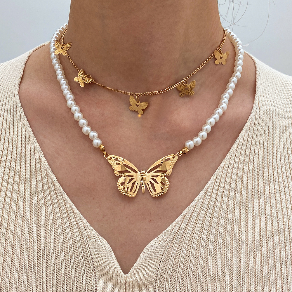 Collar de doble capa de perlas de temperamento de cadena de clavícula retro creativa mariposa hueca de doble capa transfronteriza NHPJ435924